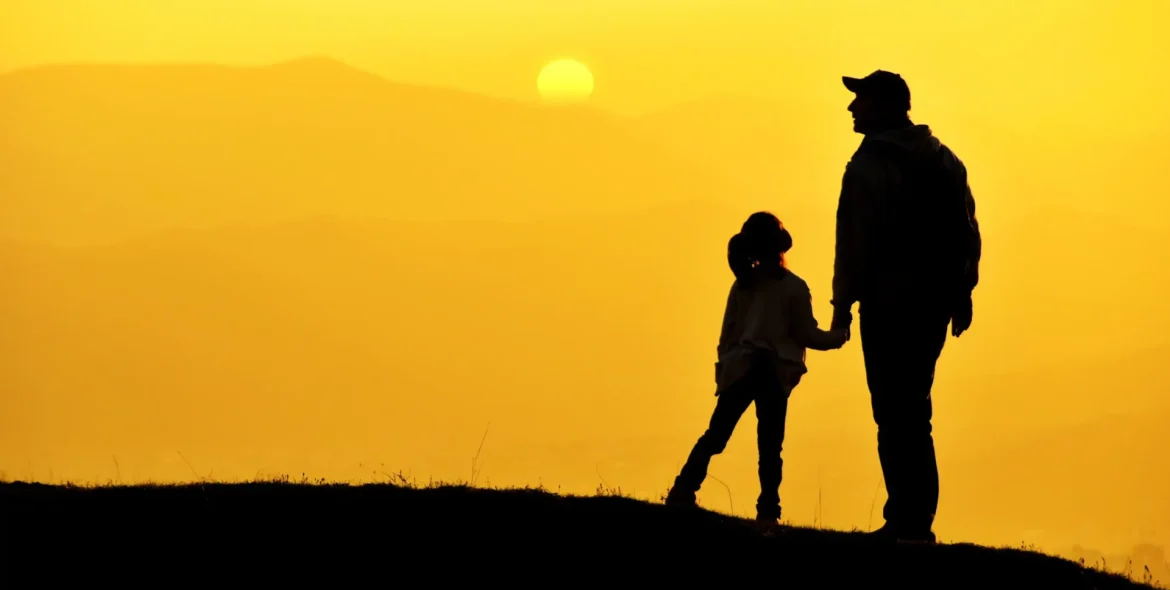 silhouette-of-adult-and-child-holding-hands-on-hil-2026-03-13-04-24-01-utc